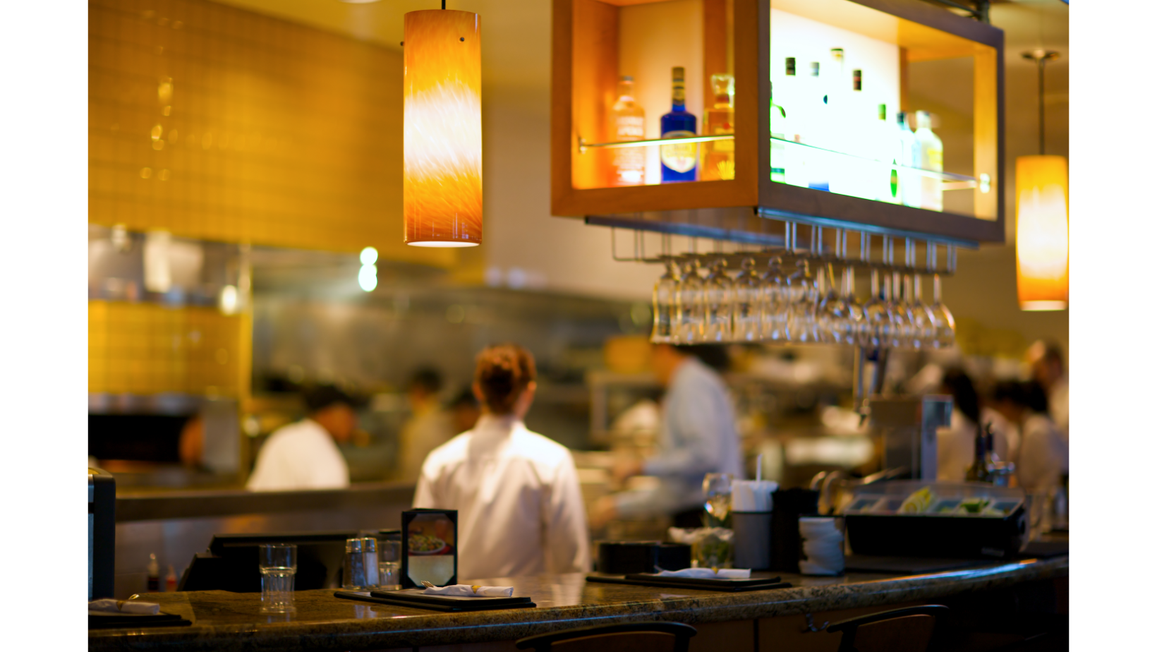 Busy Restaurant with view into open kitchen.